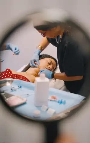 Comprehensive Strategy Project for AGE AGE professional applying aesthetic treatment to a patient's face in a clinic, seen through a magnifying glass.